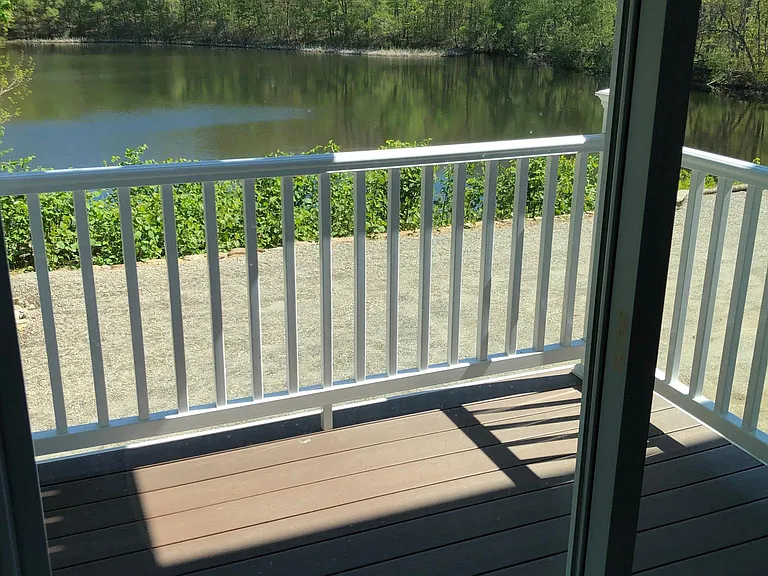 Sliding door off living/kitchen area to private balcony overlooking private lake