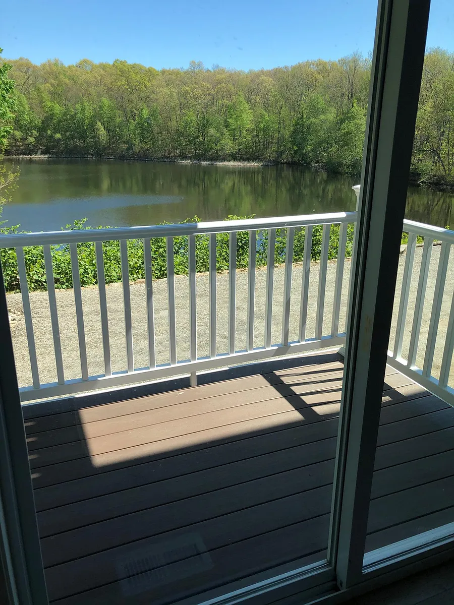 Sliding door off living/kitchen area to private balcony overlooking private lake - 697 Putnam Pike #2