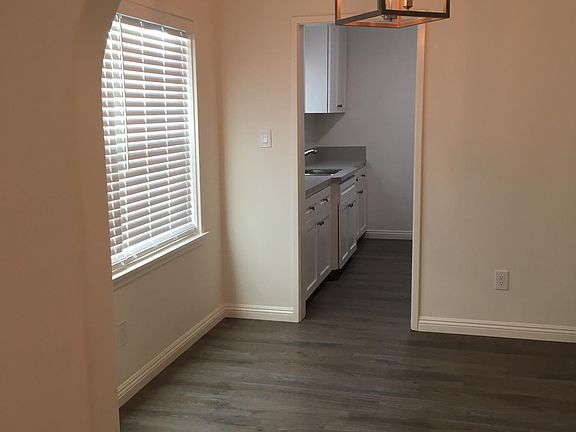 Dining Room: New windows and faux blinds. New light fixture. New vinyl plank floors.