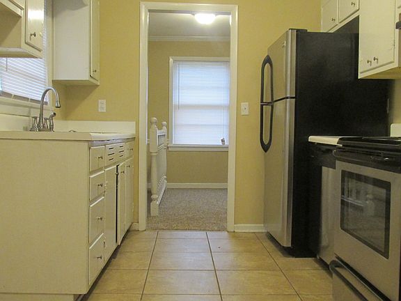 Bright Galley Kitchen with Dishwasher, Fridge and Range