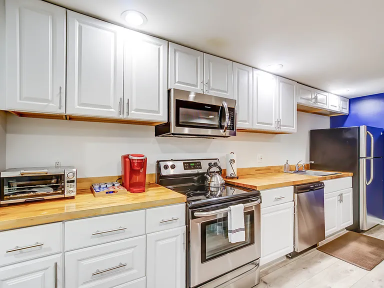 The full-sized kitchen offers abundant storage and generous prep space, making it both practical and enjoyable for everyday cooking.