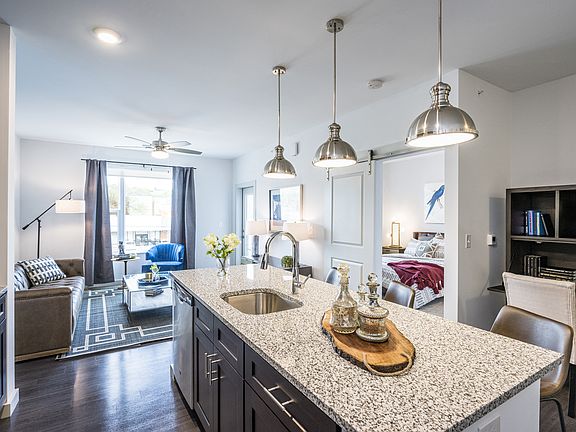 Stylish Pendant Lighting, Granite-Style Countertops, and Wood-Style Flooring