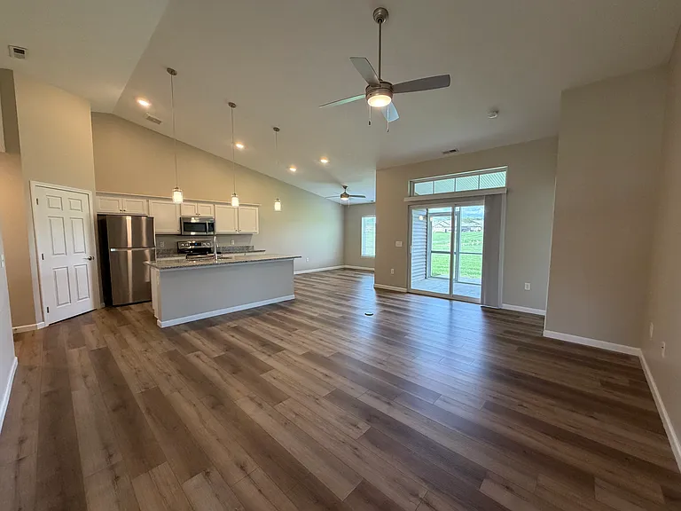 View from entry hallway of the living room, kitchen, and dining room.
