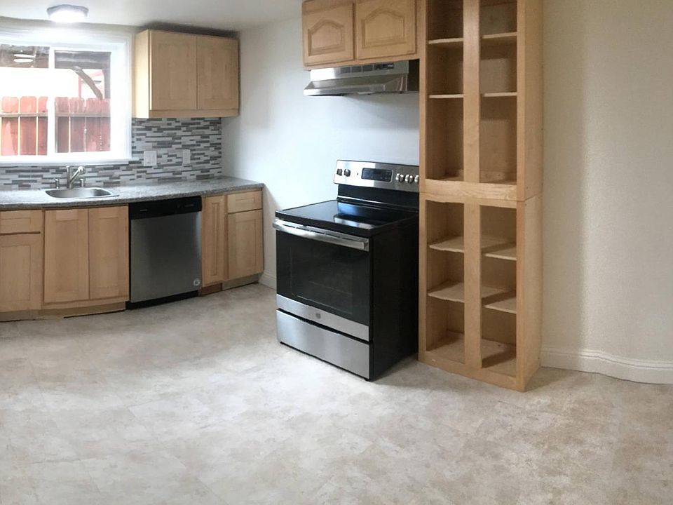 Kitchen with new refrigerator, dishwasher and electric oven