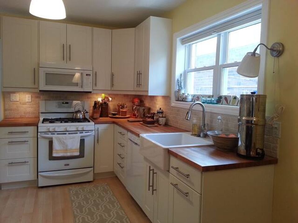 bright kitchen, gas stove, dishwasher, farmhouse sink, butcher block counters