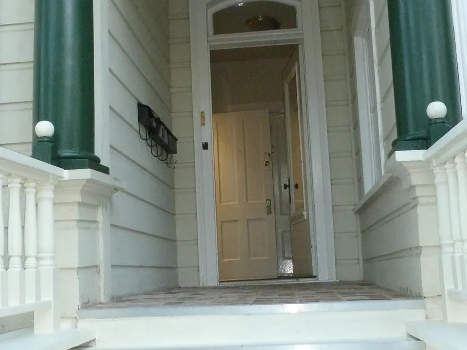Stairs to wood and glass front door to enter property 