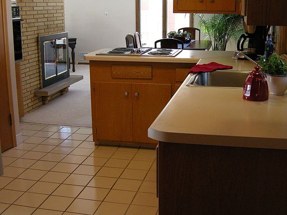 Kichen with a indoor grill and pantry.