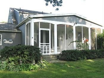 A screened porch in back of house