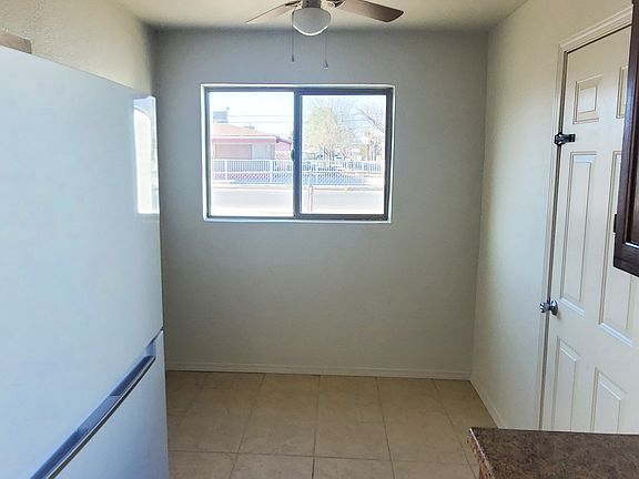 Kitchen space, window, fan, and back door exit