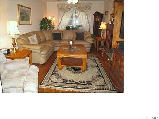 Large living room with three French doors and hardwood floors.