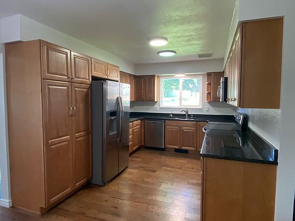 Large remodeled kitchen with granite countertops, stainless steel appliances, and undercabinet lighting. Separate tap with filtered water at the sink.