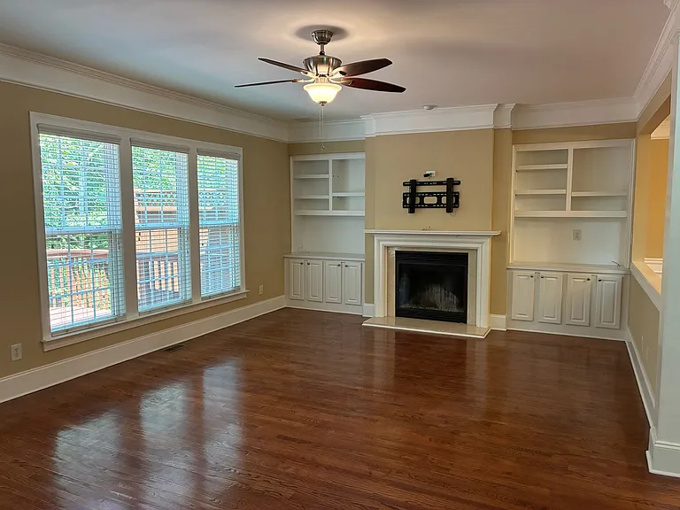 Living Room with built in book shelves and fireplace with view to the deck