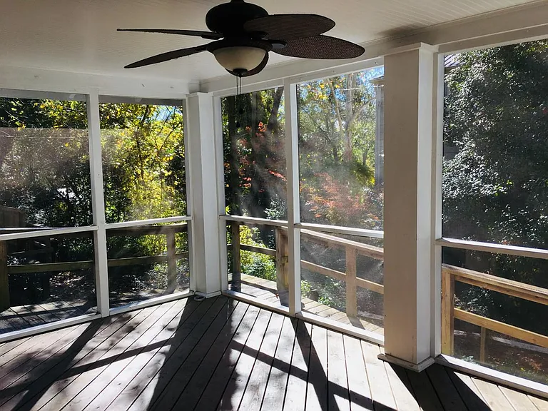 spacious screened-in porch with ceiling fan