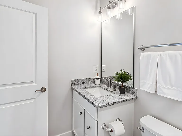 Well-appointed full bathroom conveniently located adjacent to the secondary bedroom.