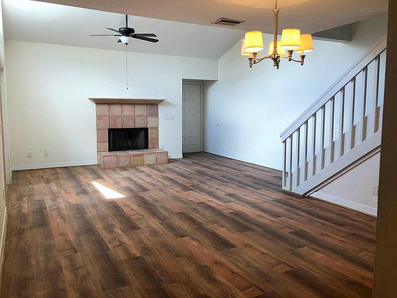 Open floor plan with high ceilings and electric fireplace