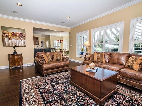 Spacious Family Room with crown molding and gas fireplace. Lots of natural light from the many windo