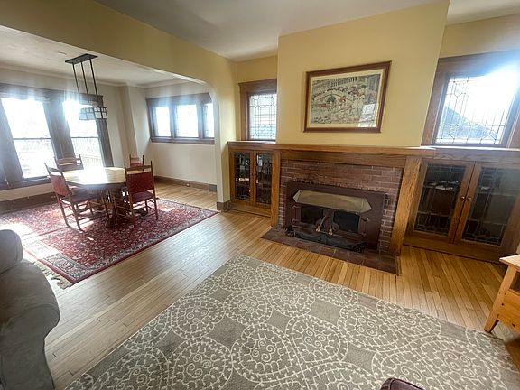 living and dining room featuring original 1920 built in bookshelves and leaded glass windows