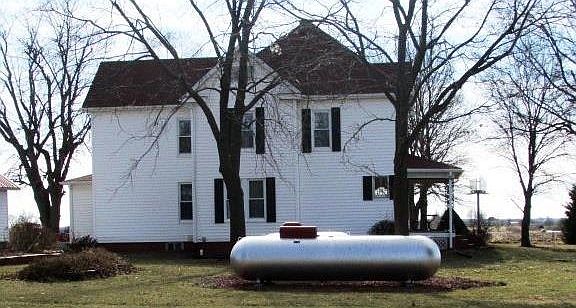 Backyard view:  Propane tanks go with the home, and even have red tops to match the buildings!