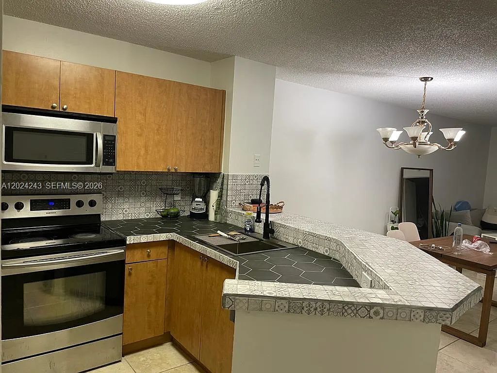 Building Photo - 8750 N Sherman Cir #208