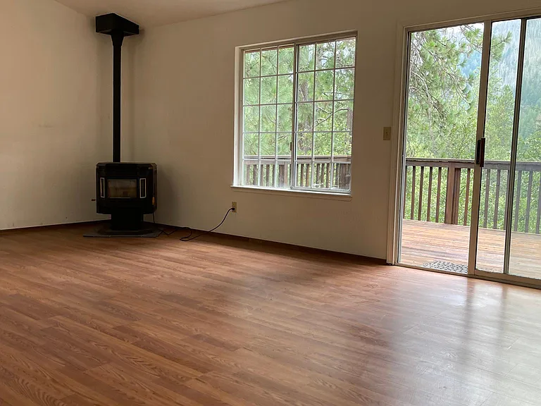 Family room with siding door leading out to the backyard deck.