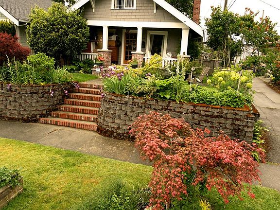 Craftsman home, built in 1917 with covered porch and lots of blooming plants!