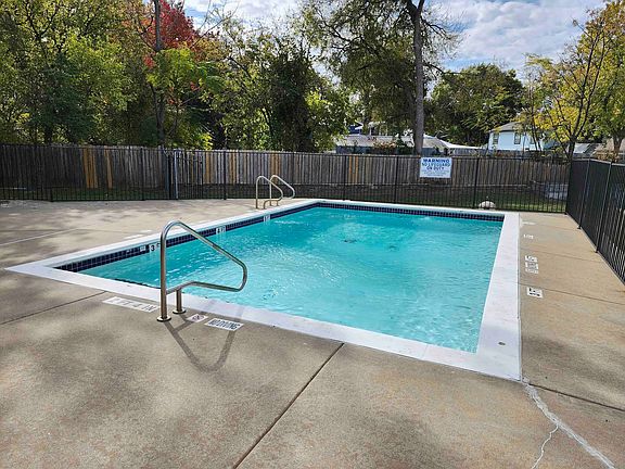 Enjoy serene moments at this picturesque outdoor pool, a haven of relaxation.