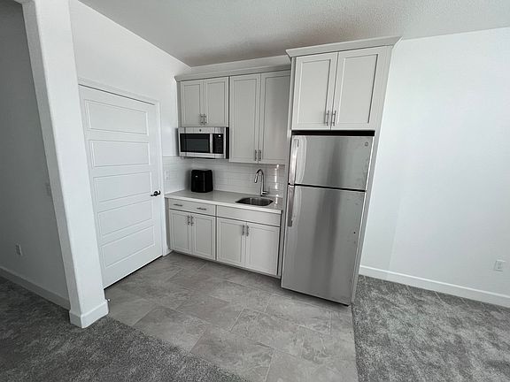 Stainless steel microwave, refrigerator and sink.