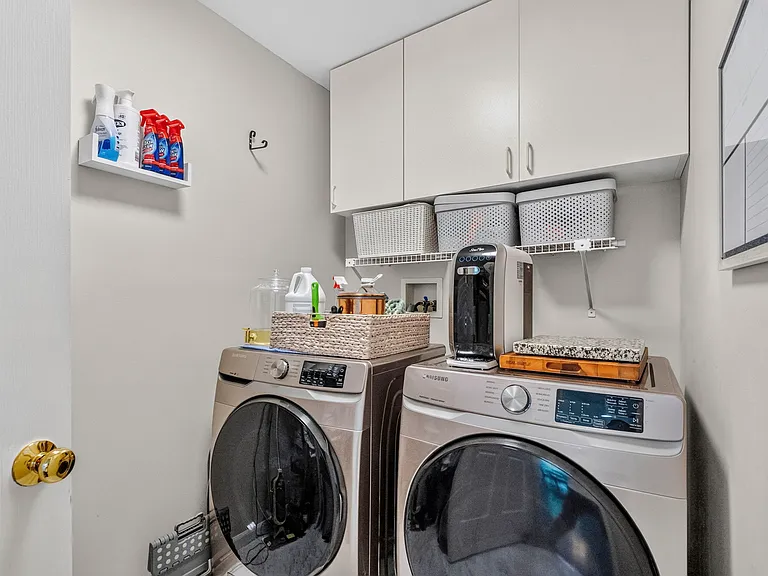Laundry Room with Ample Overhead Cabinet Storage and Shelving, and Convenient Main Level Access