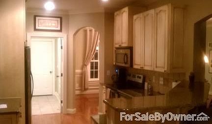 custom cabinets, archways in kitchen/living areas