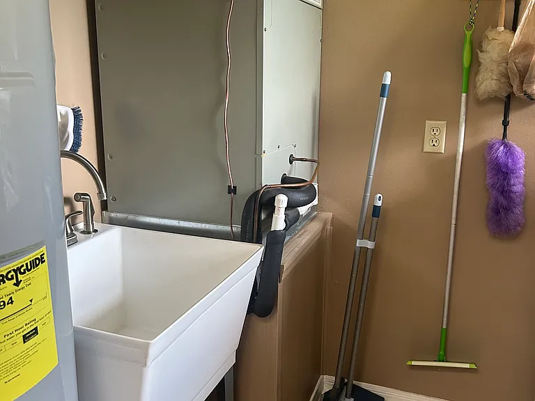 Utility sink, hot water heater, air return, cleaning supplies