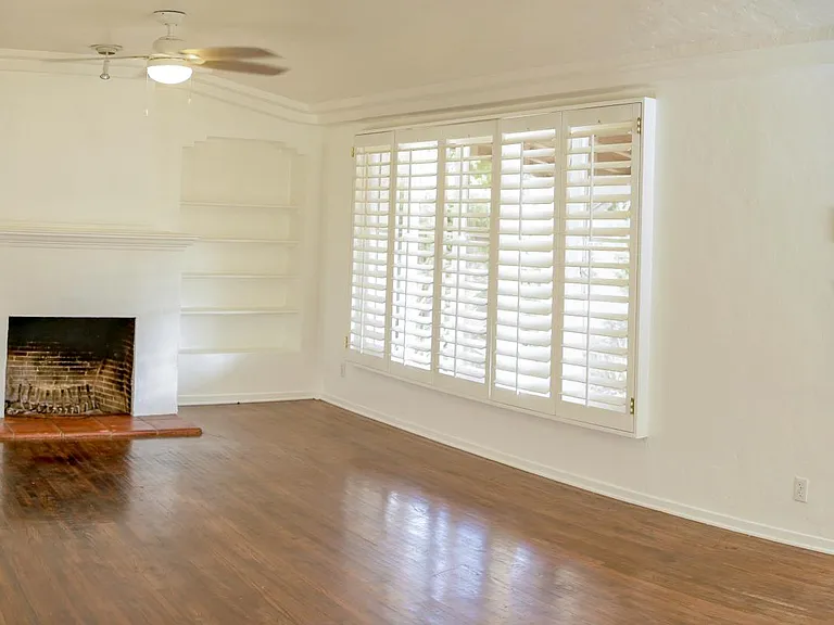 Living Room. Working fireplace. California shutters. Newly refinished wood floors.