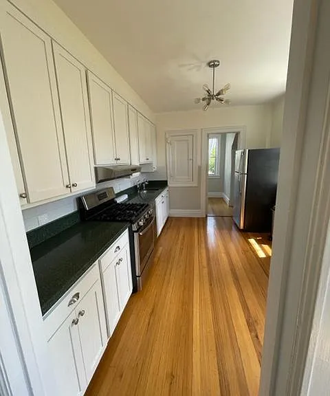 Eat in kitchen with stone countertops and stainless steel appliances.