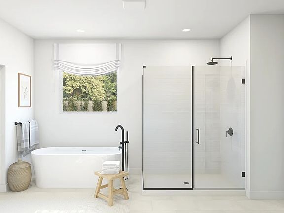 Primary bath with glass shower enclosure and freestanding tub