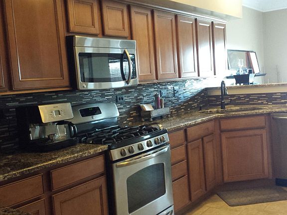 Kitchen with granite tops and stainless steel appliances