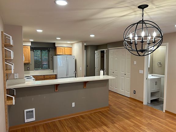 Living area looking toward front and kitchen with breakfast bar.