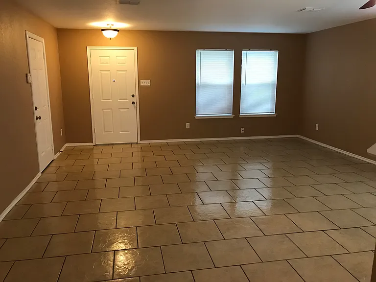 Front door and garage door to left.