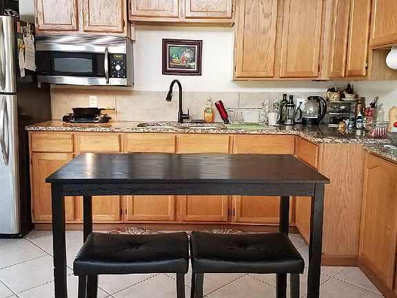 Kitchen is open to the living room, Has nice size refrigerator, convection/microwave oven and electric cooktop.