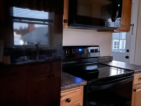 Galley kitchen with back porch access.