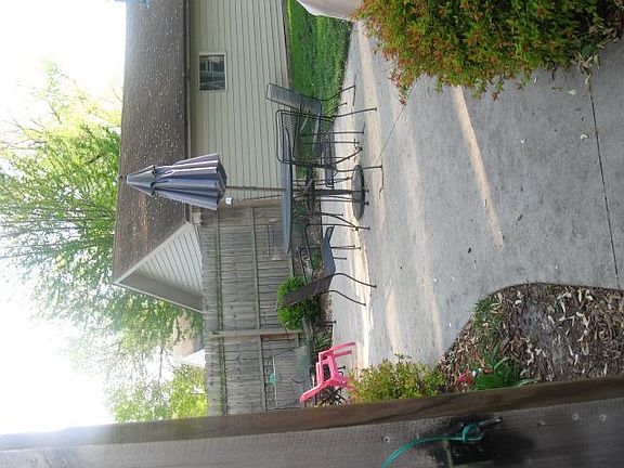 Fenced in backyard with a beautiful patio and garden area