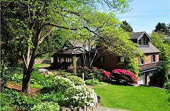 Stunning landscaped view of side of House