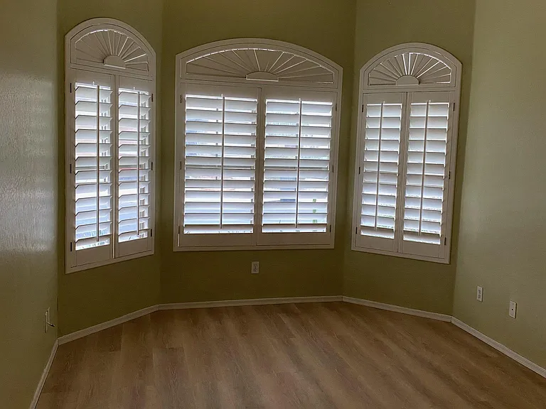 Bedroom 2. Plantation shutters, Hunter ceiling fan with light, brand new L.V.P. laminate flooring and fresh paint. Picture taken November 16, 2023 afternoon.