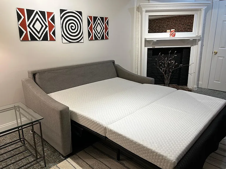 Living room sofa opens up to queen-sized bed with integrated latex mattress. Super comfortable!