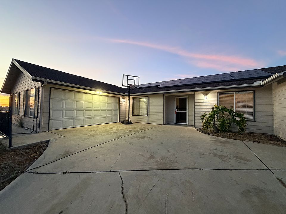 Front Exterior w/ 2 car garage and front entry way.