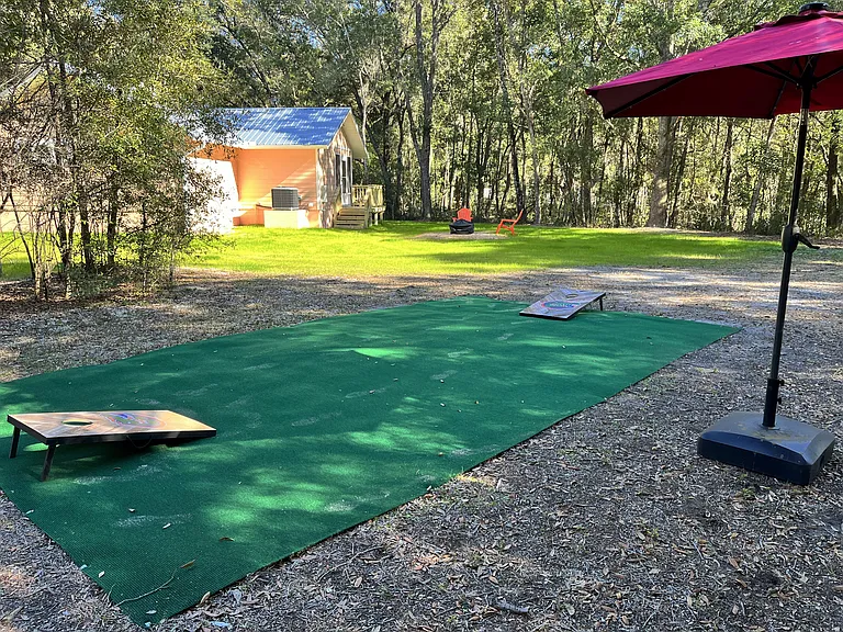 A shared Corn Hole pad and game provides for a fun competition