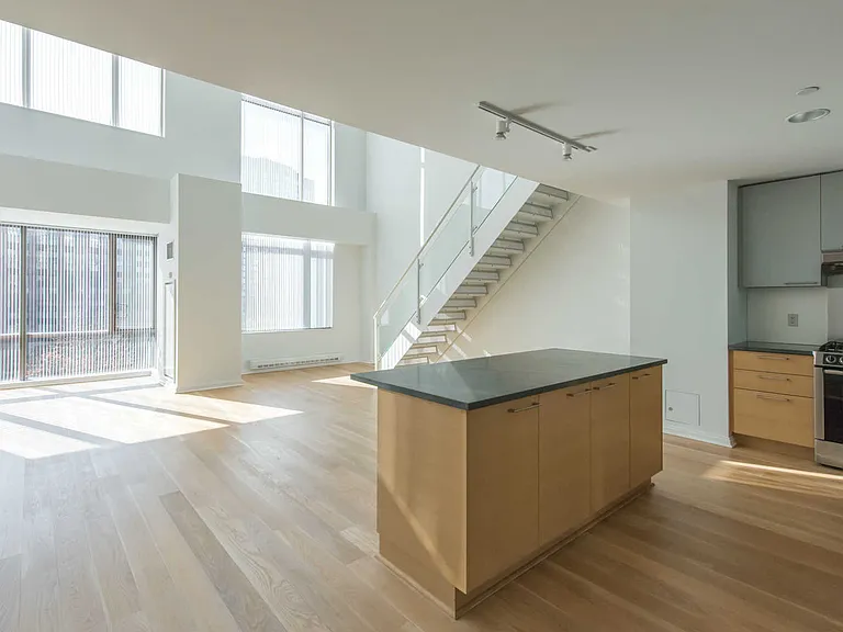 Eat-in Island Kitchen and Dining Area with Floor-to-Ceiling Windows
