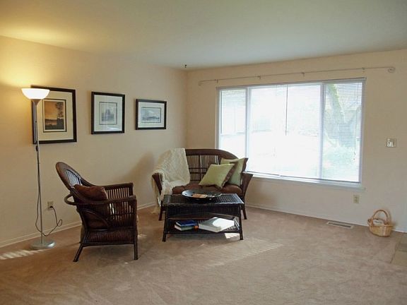 Nice sized living room offers new carpet and paint and a lovely view of the garden.