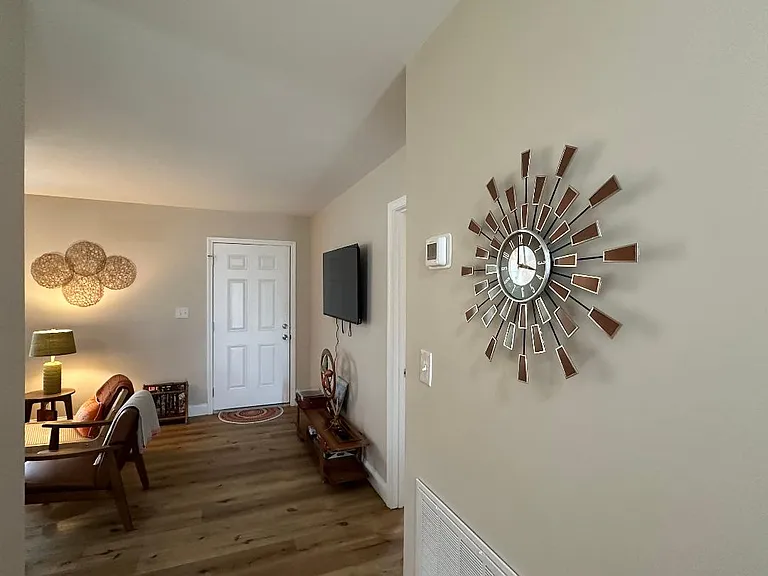 Extra wide hallway leading to bedrooms and living room