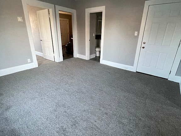Spacious living room with new gray plush carpet