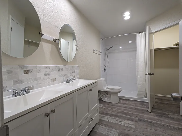 Master Bathroom with Dual Vanities and Dual Walk-in Closets