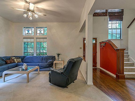 Formal living room with many windows for natural light.
